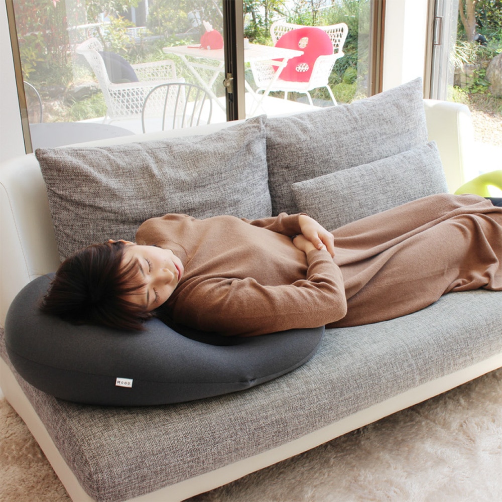 ソファの上で、ビーズクッションを枕がわりにしながらお昼寝する女性